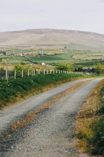a dirt road in the middle of a field at North Coast 9 Glamping in Cape Castle