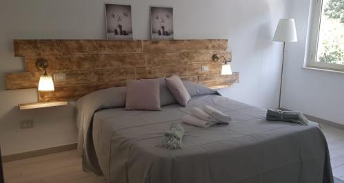a bedroom with a bed with two pillows on it at Casa Vacanza Mata in Zambrone