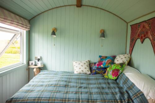 a bedroom with a bed in a room with a window at Mulsford Cottage in Malpas