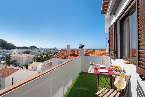 a balcony with a table and chairs on a roof at Ouramar Apartment in Areias de São João