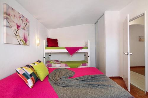 a bedroom with a bed with a pink blanket at Ouramar Apartment in Areias de São João