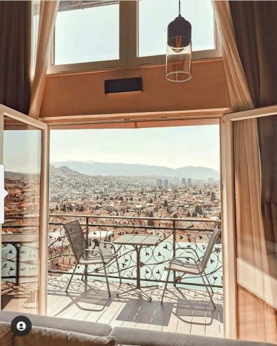 a balcony with a table and chairs and a view at Sarajevo Sky View in Sarajevo