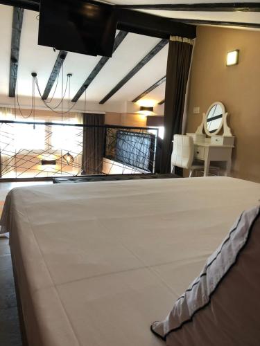 a room with a bed in a room with a clock at Sarajevo Sky View in Sarajevo