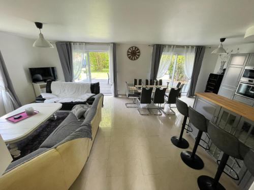 a living room with a couch and a table at LA MAISON DE DELSY in Binson-et-Orquigny
