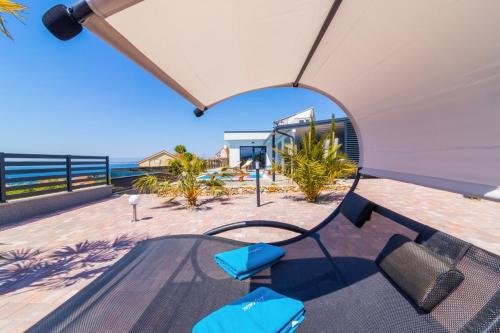 a table and chairs with a view of the beach at Villa Belissima Vista Mare in Selce