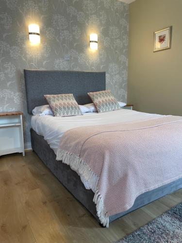 a bedroom with a large bed with two pillows at Killilagh Accommodation in Doolin