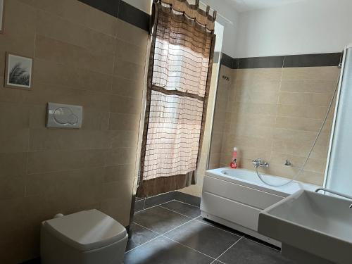 a bathroom with a tub and a toilet and a sink at Serena e’ in Viterbo