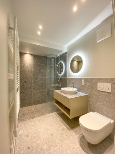 a bathroom with a toilet and a sink at Blackhome Wien I contactless check-in in Vienna