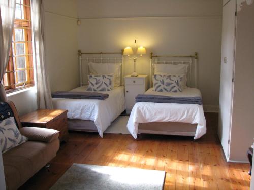 a living room with two beds and a couch at Kaiser's B&B in Grahamstown