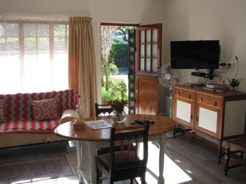 a living room with a table and a couch at Kaiser's B&B in Grahamstown