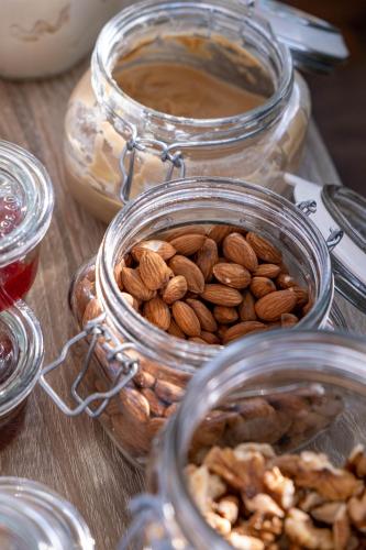 a group of glass jars filled with nuts on a table at C Suites in Rethymno Town
