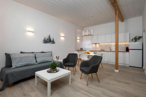 a living room with a couch and chairs and a table at Onyx in Gimari
