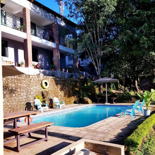 a swimming pool in front of a building at Chinyonga Guesthouse in Limbe