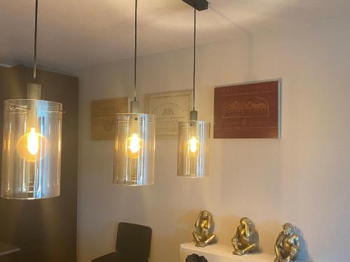 a room with four lights hanging from the ceiling at Scheveningen Diamond View Beach and Harbour in Scheveningen