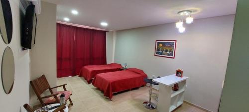 a room with two beds and a red blanket at Fenix 4 in Formosa
