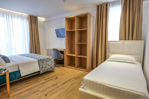 Кровать или кровати в номере Bora Bora Hotel Ksamil