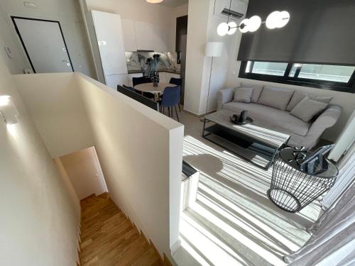a living room with a couch and a table at Athenean Modern Escape near Marina Flisvos in Athens