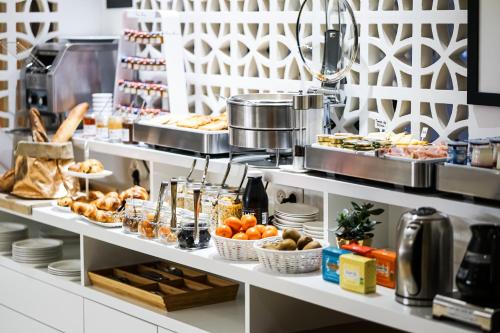 a buffet line with various food items on display at Hôtel Le Collonges TV connecté wifi Netflix in Brive-la-Gaillarde