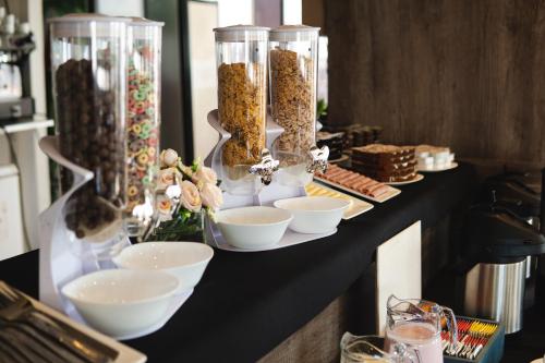 a table topped with bowls and vases filled with food at Isi Baires Alquiler Temporario in Buenos Aires