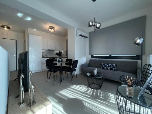 a living room with a couch and a table at Athenean Modern Escape near Marina Flisvos in Athens