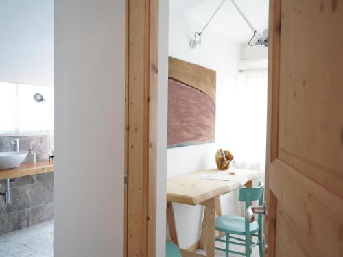 a kitchen and dining room with a table and chairs at B&B Porto Del Bivio in Duino