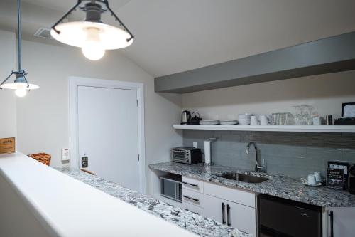 a kitchen with granite counter tops and a sink at Kemptville Suites in Kemptville