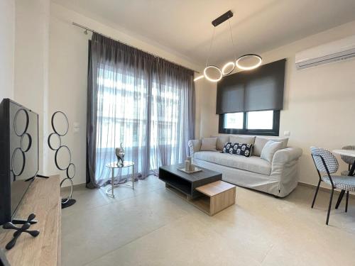 a living room with a couch and a table at Athenean Modern Escape near Marina Flisvos in Athens
