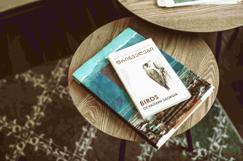 a wooden table with two books on it at Duende Hotel in Lagodekhi