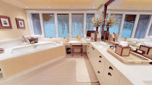 a large bathroom with a tub and a sink at Trails Edge by Snowmass Vacations in Aspen