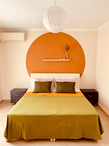 a bedroom with a large bed with a wooden headboard at Family Tree - WATER Available - SELF check in in Golem