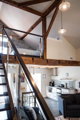 a staircase leading up to a living room and kitchen at Kemptville Suites in Kemptville