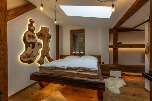 a bedroom with a bed in a room with wooden floors at Javor apartmán na Šumavě in Železná Ruda