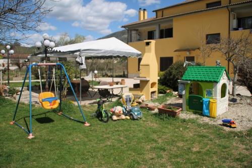 a backyard with a swing set and a playground at Mansarda con camino in Montefranco