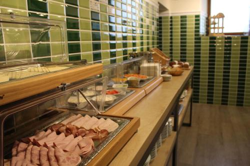 a buffet line with many different types of food at Hotel Miriquidi All Inklusive in Kurort Oberwiesenthal