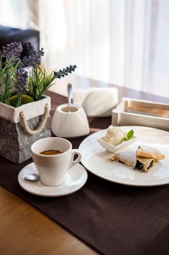a table with two plates of food and a cup of coffee at Kolobok in Luts'k