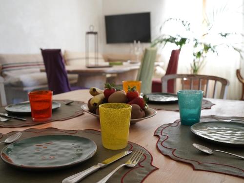 a wooden table with plates and utensils on it at B&B Porto Del Bivio in Duino