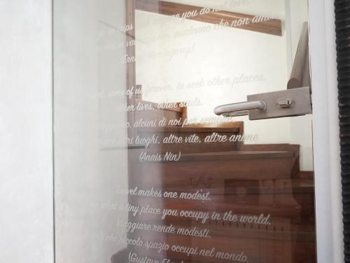 a picture of a stairwell with a door with words on it at B&B Porto Del Bivio in Duino