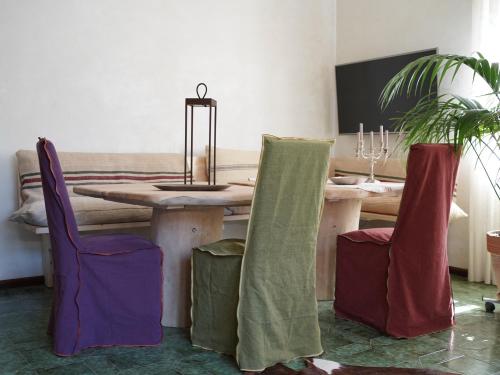 a dining room with a wooden table and chairs at B&B Porto Del Bivio in Duino