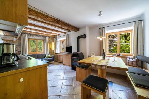 a kitchen and living room with a table and chairs at Ansitz Gurtenhof - Andreas Hofer in Tesimo