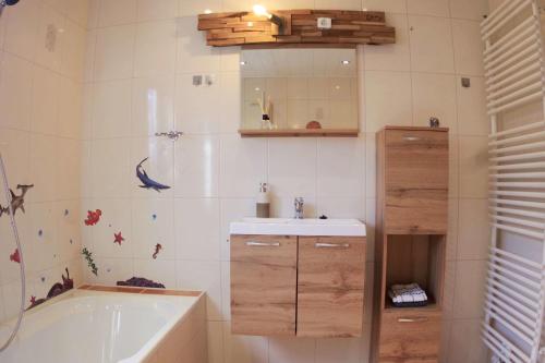 a bathroom with a tub and a sink and a bath tub at Seepirat Pepe in Walchum