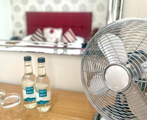 two bottles of water and a fan on a table at Langham Hotel Eastbourne in Eastbourne