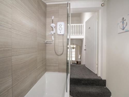 a shower with a glass door in a bathroom at Willowbank in Ayr