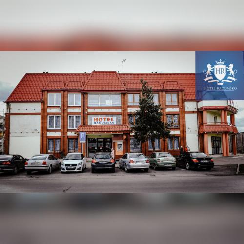 a large building with cars parked in a parking lot at HOTEL RADOMSKO in Radomsko