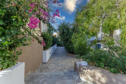 a stone walkway with flowers and plants on a building at Your Memories Hotel in Gouves