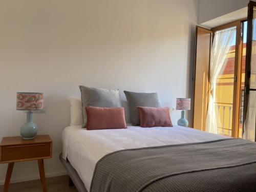 um quarto com uma cama grande e 2 almofadas em Hispalis Jardines de Murillo em Sevilha