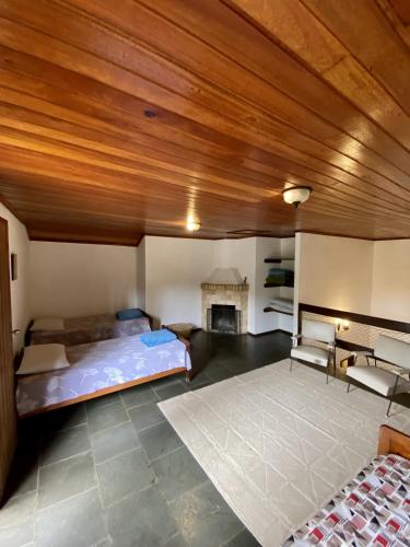 a large room with a bed and a fireplace at Hotel Fazenda São Moritz in Teresópolis