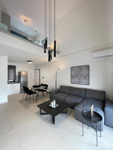 a living room with a couch and a table at Athenean Modern Escape near Marina Flisvos in Athens