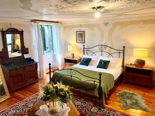 a bedroom with a bed and a mirror at Villa De Rubeis Florit in Tarcento