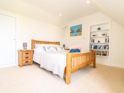 a bedroom with a bed and a book shelf at Higher Kernick View in Bodmin