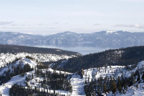 a view of a snow covered mountain and a lake at Scott Peak Lodges Condo in Alpine Meadows